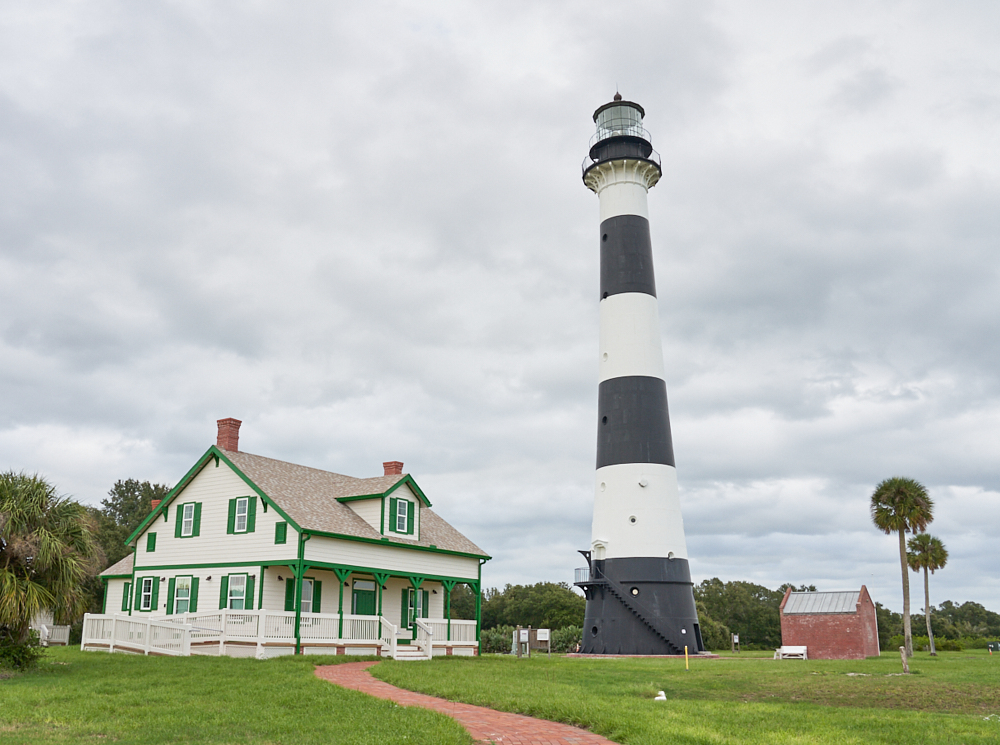 Cape Canaveral Lighthouse with the keeper's cottage in the foreground, showing the restored 1894 daymark pattern.